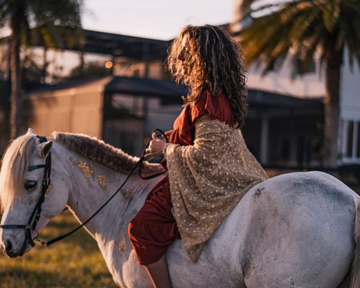 Ellli rides her white Icelandic horse Solomon