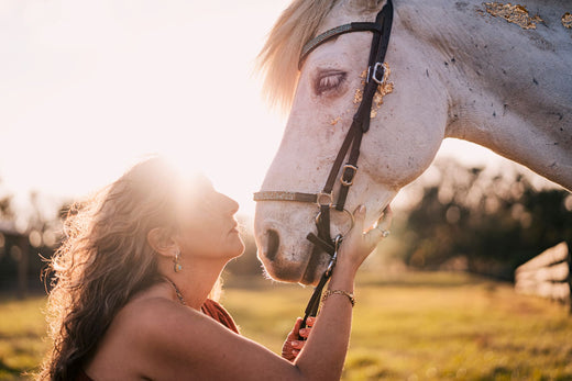 Elli and Solomon stand face to face, illuminated by the glow of the sun